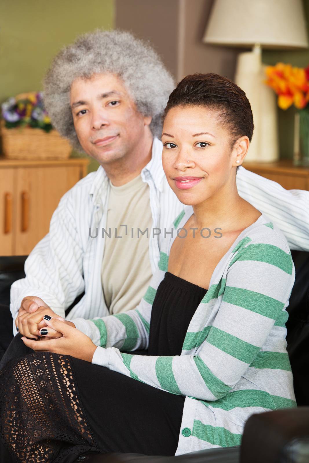 Attractive young and middle aged Black couple holding hands