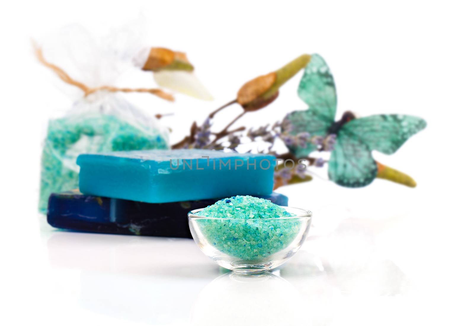 Spa treatment with turquoise bath salts, on white background