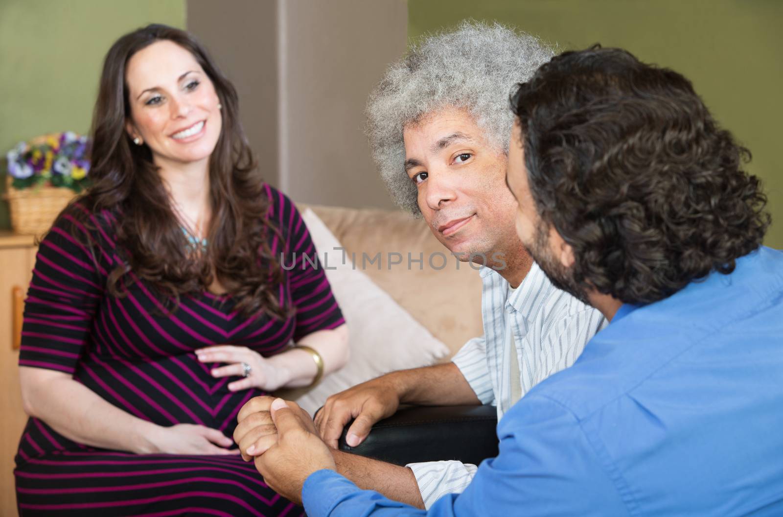 Smiling surrogate mother with gay Hispanic couple