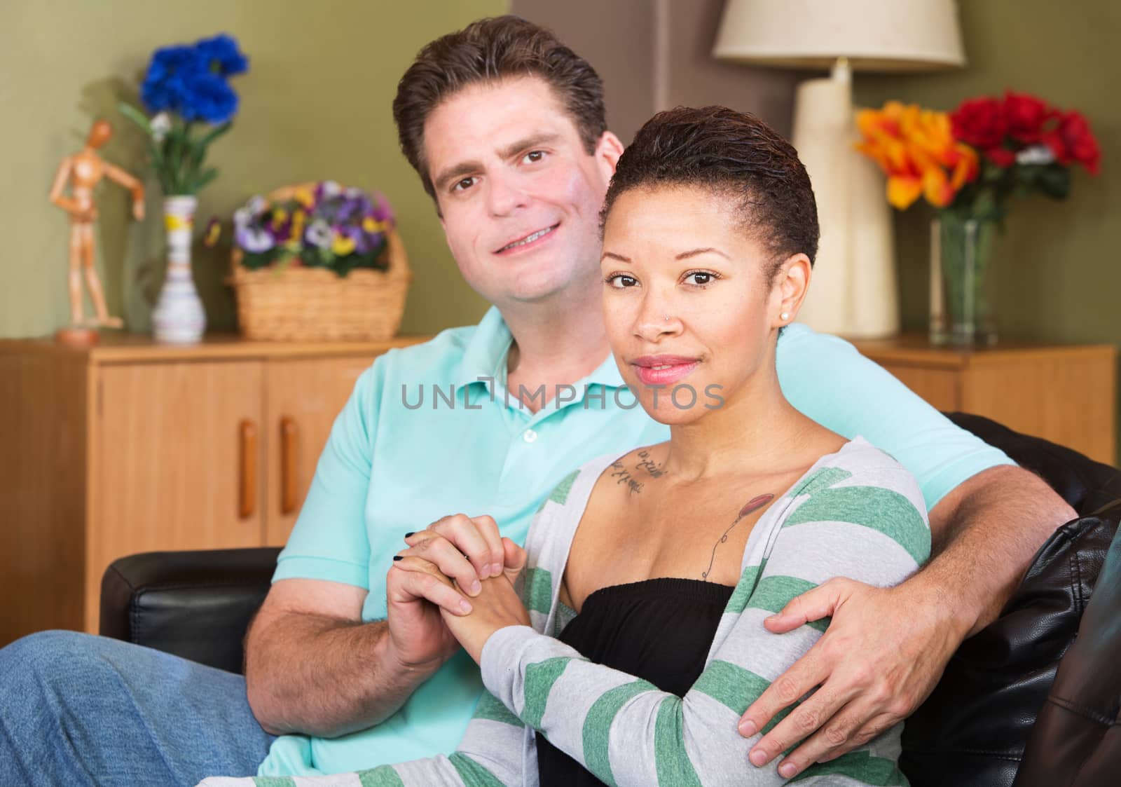 Cheerful young mixed Black and White couple holding hands
