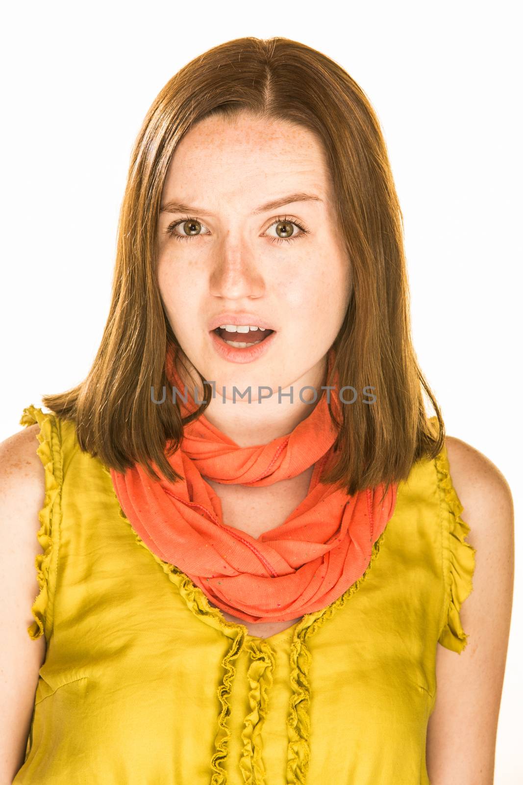 Pretty girl with a confused expression on white background