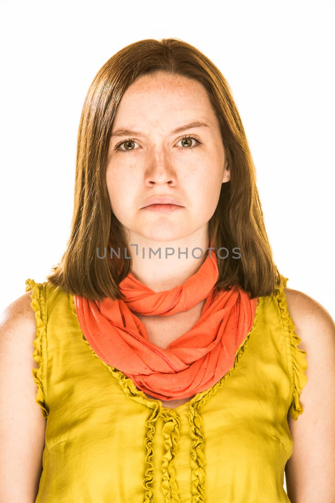 Pretty girl with an unhappy expression on white background