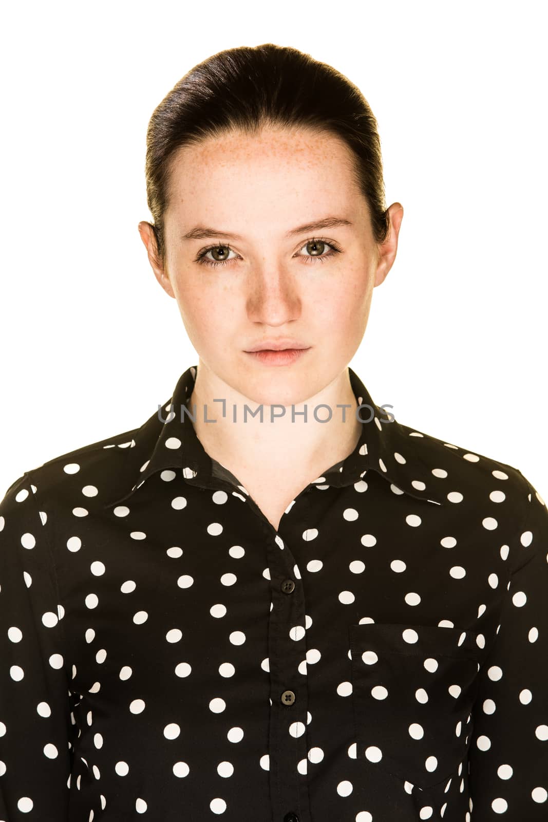 An irritated young girl on a white background