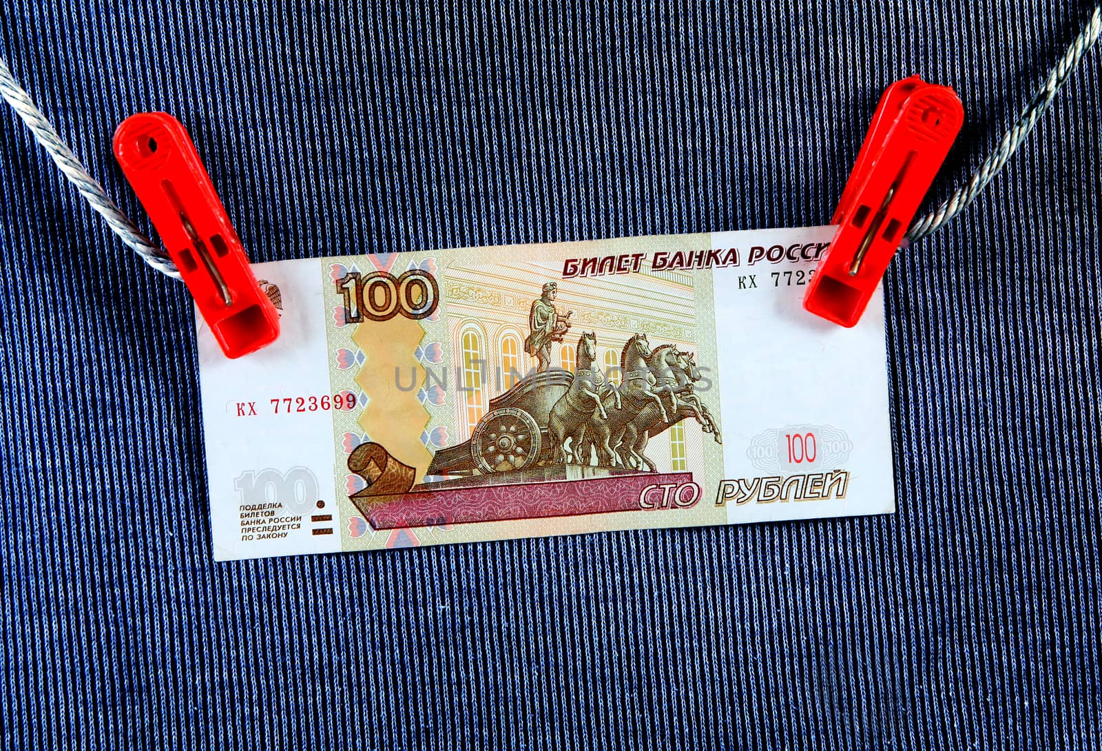Hundred Russian Rubles on the Rope and the Textile Background