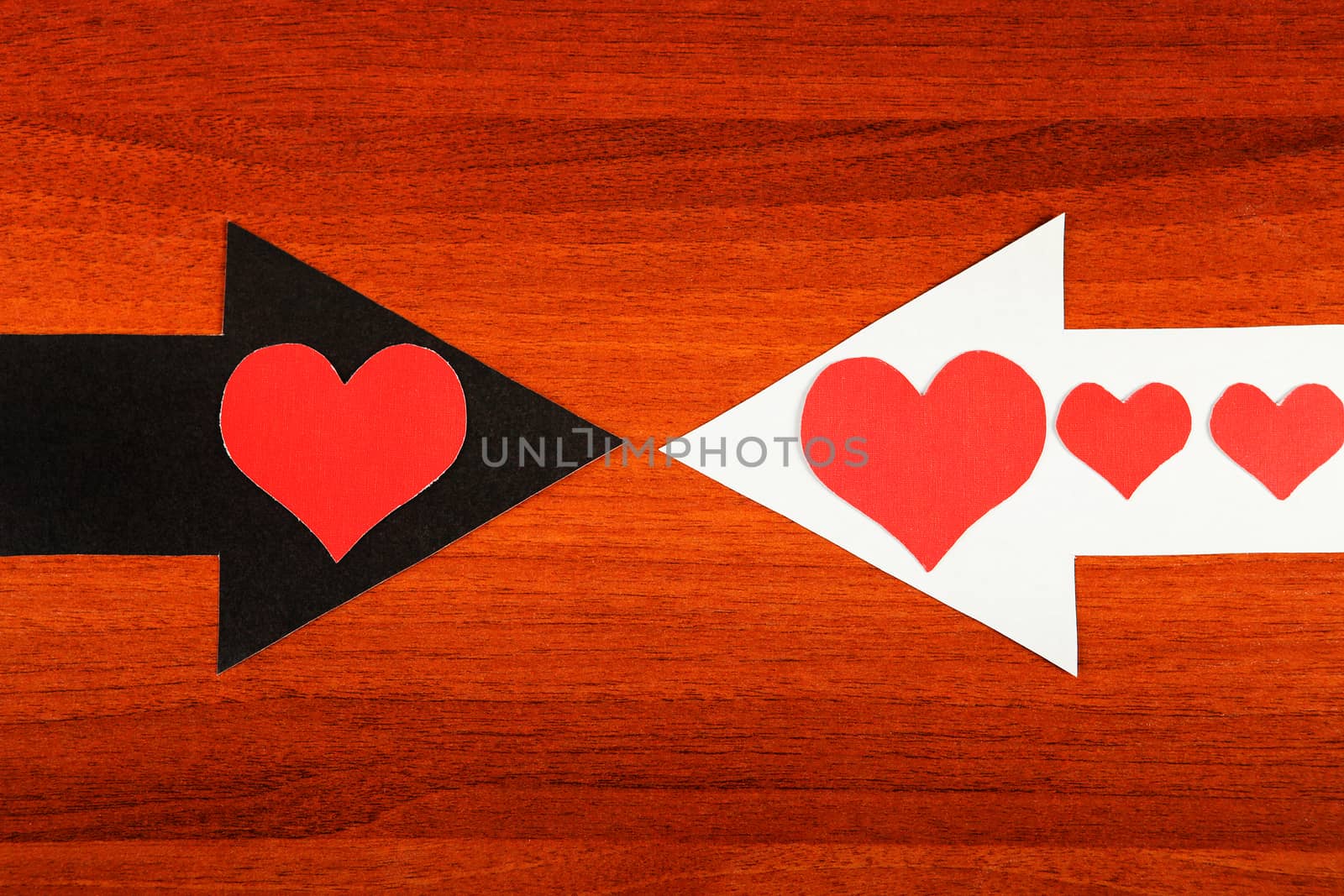 Heart Shapes on the Black and White Arrows on the Wooden Background