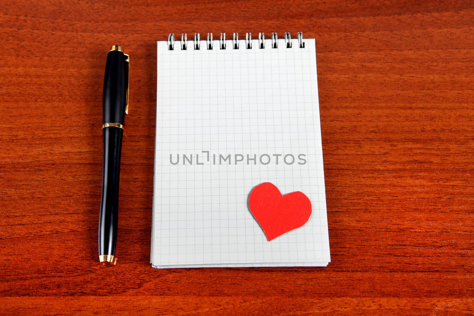Blank Writing Pad with Heart Shape and Pen on The Table