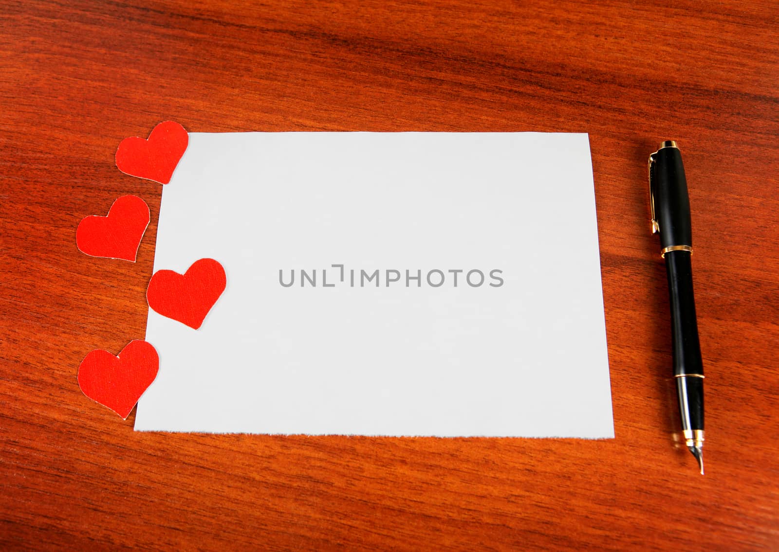 Blank Writing Pad with Heart Shapes and Pen on The Table