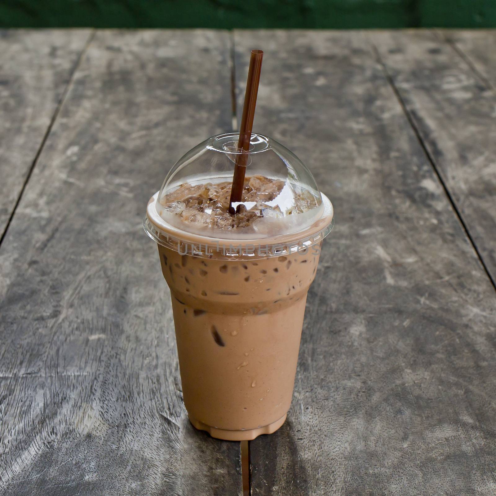 Cold coffee drink with ice on old wood table by art9858