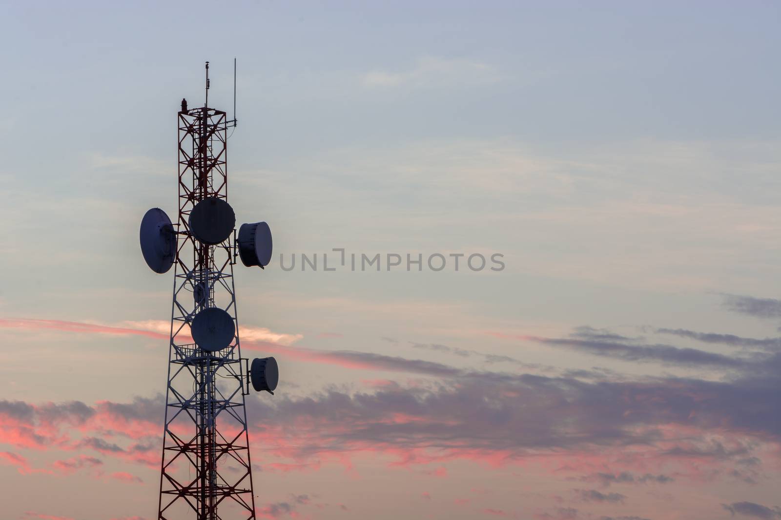 Telecommunication tower structure with sunset sky background 