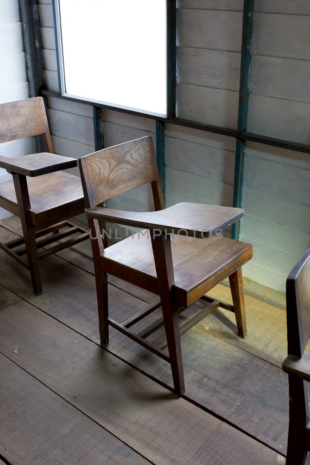 Vintage a school chair with a fold-up tablet/desk made from wood.