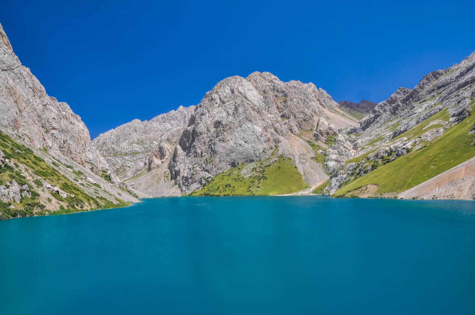 Scenic turquoise lake in mountain range Tien-Shan in Kyrgyzstan