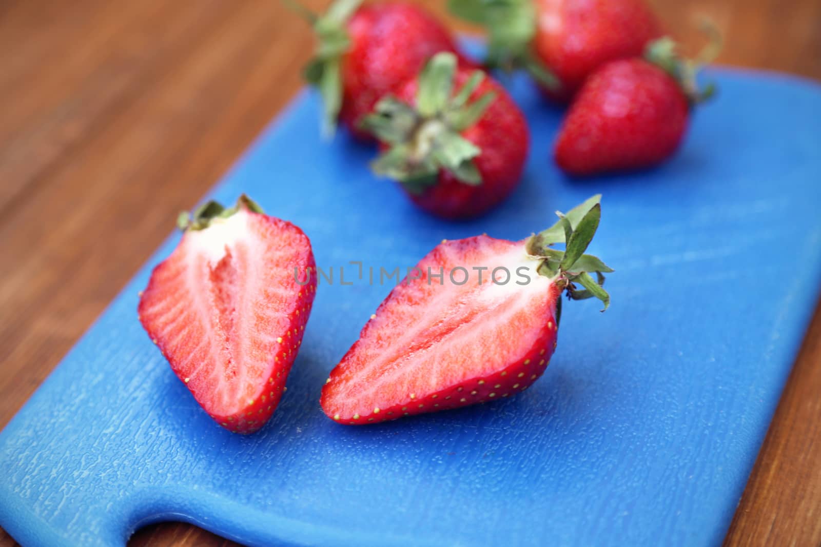 some red ripe,fresh strawberry on blue plate