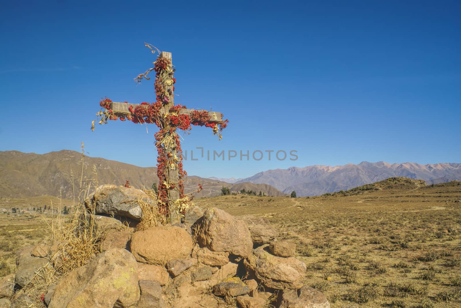 Christian cross on peruvian arid landscape near Canon del Colca