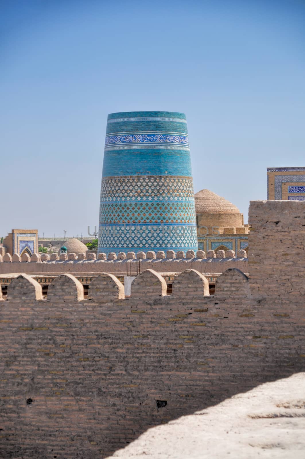 Blue decorated minaret in Khiva, historical town in Uzbekistan