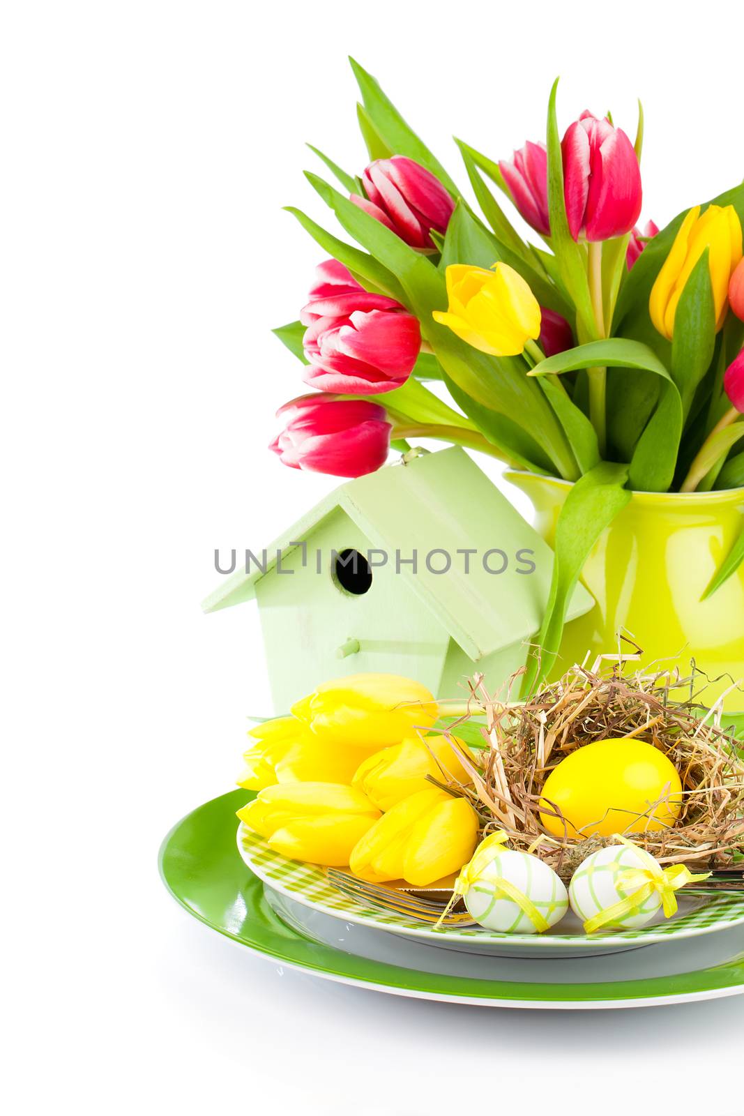 Easter eggs with tulips flowers and birdhouse, on a white background