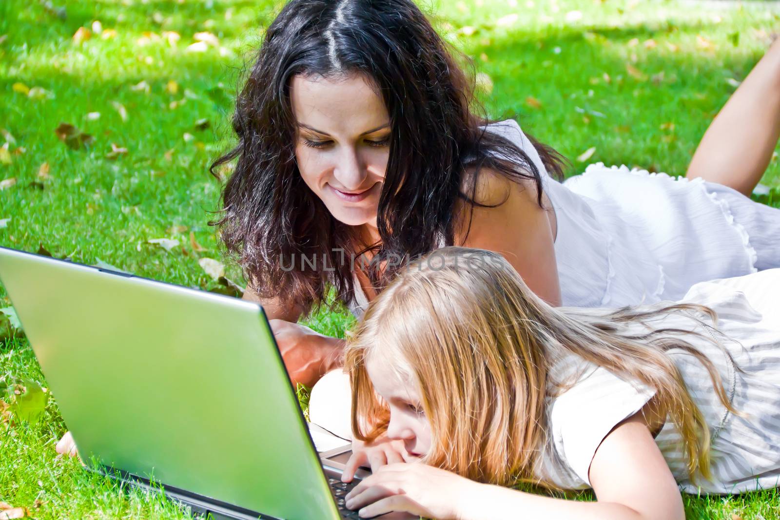 Photo of learning mother and daughter in summer