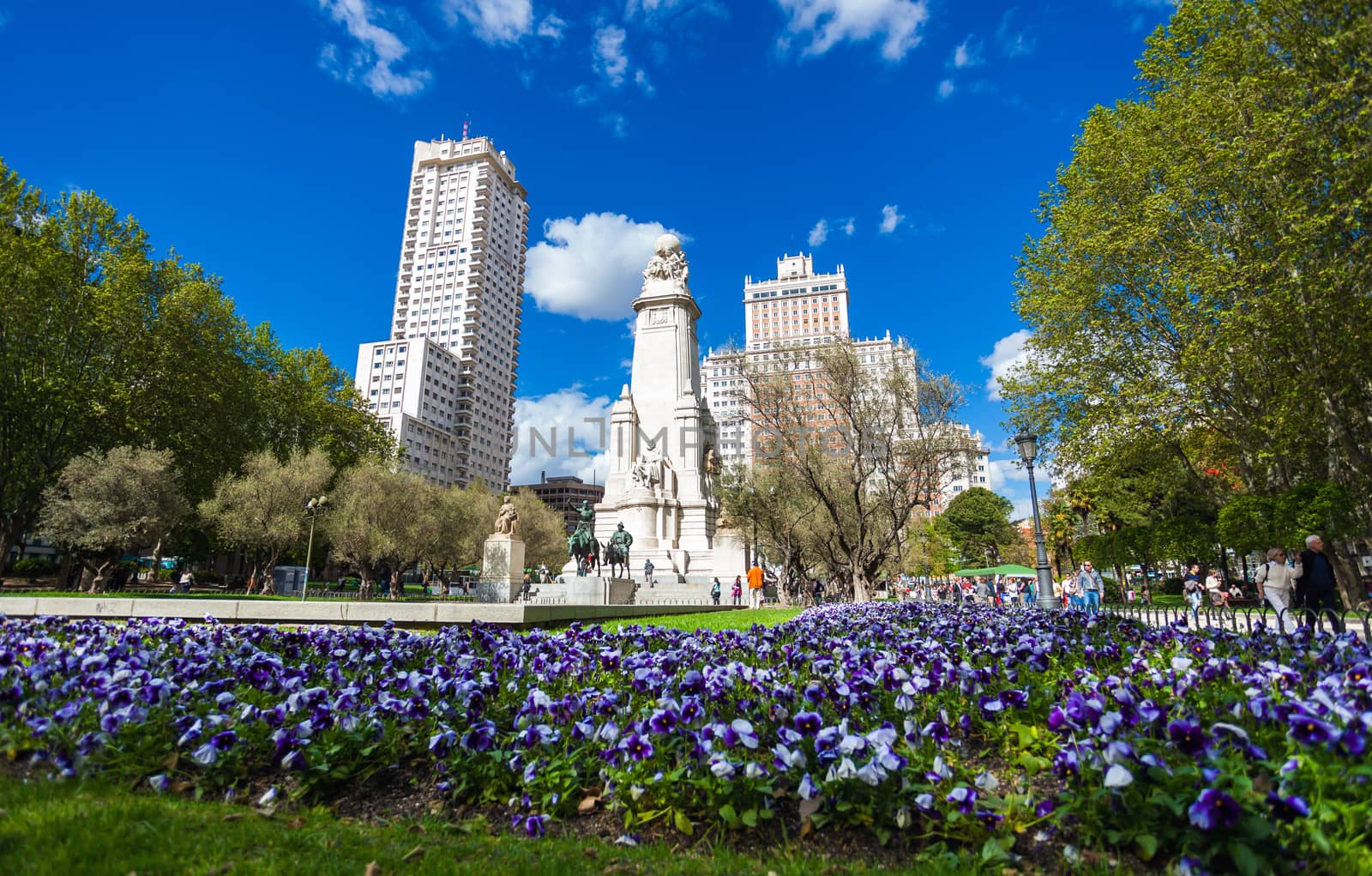 Madrid, Spain - May 6, 2012: Spain Square with monument to Cervantes, Torre de Madrid and Edificio Espana in Madrid on a sunny spring day, Spain