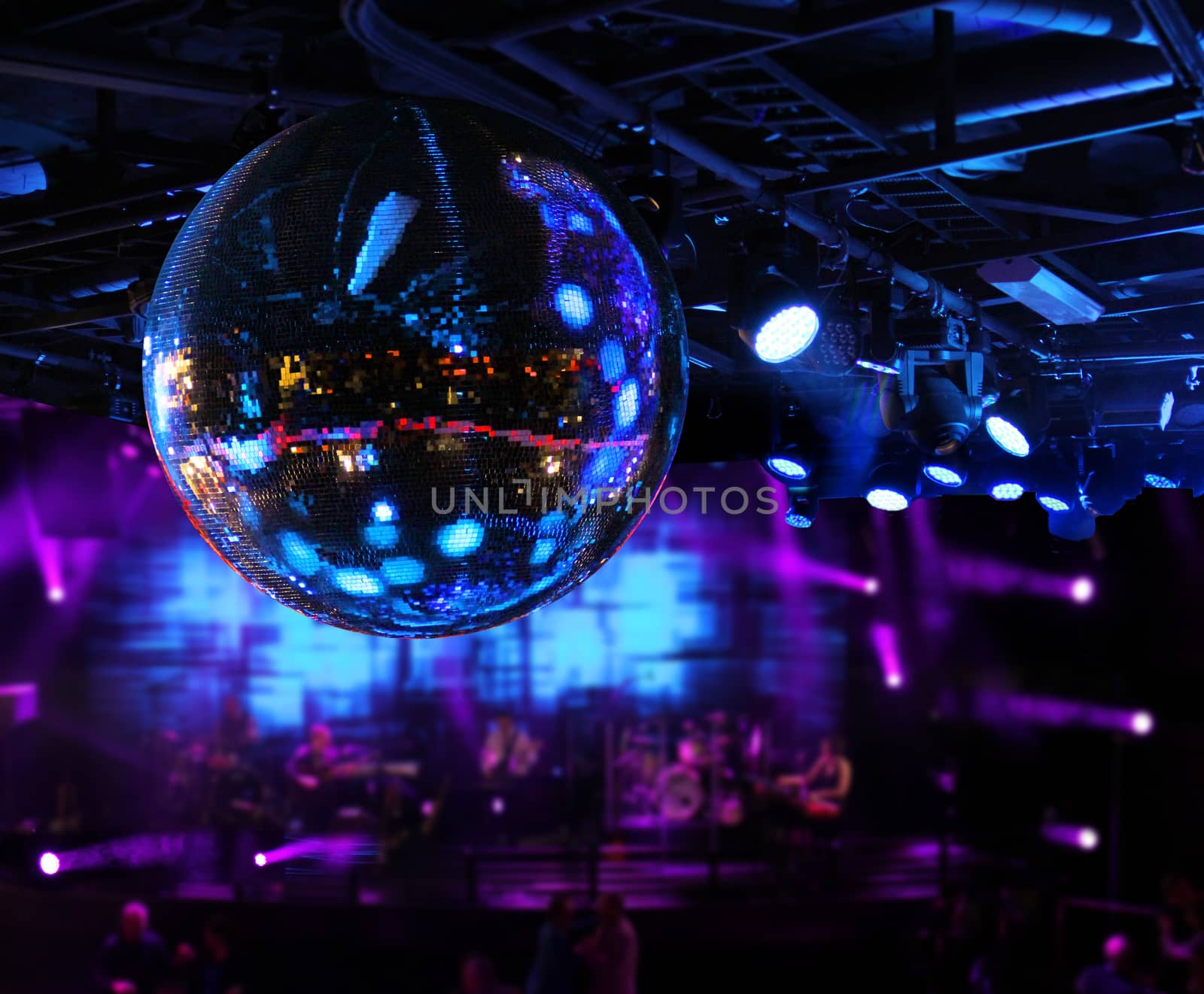 Band playing under disco mirror ball by anterovium