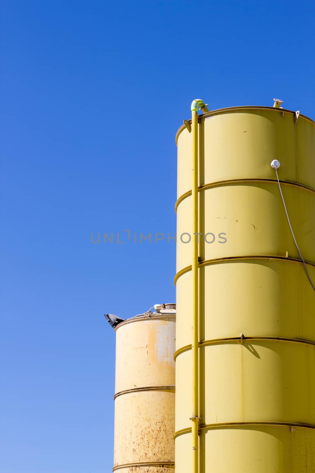 Two silos yellow by Carbonas