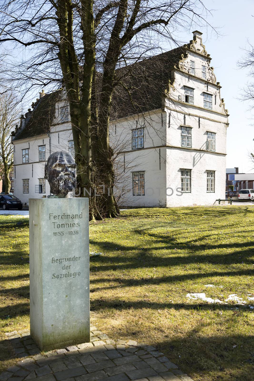 Image of a statue of the founder of sociology and the gatehouse in Husum Northern Germany