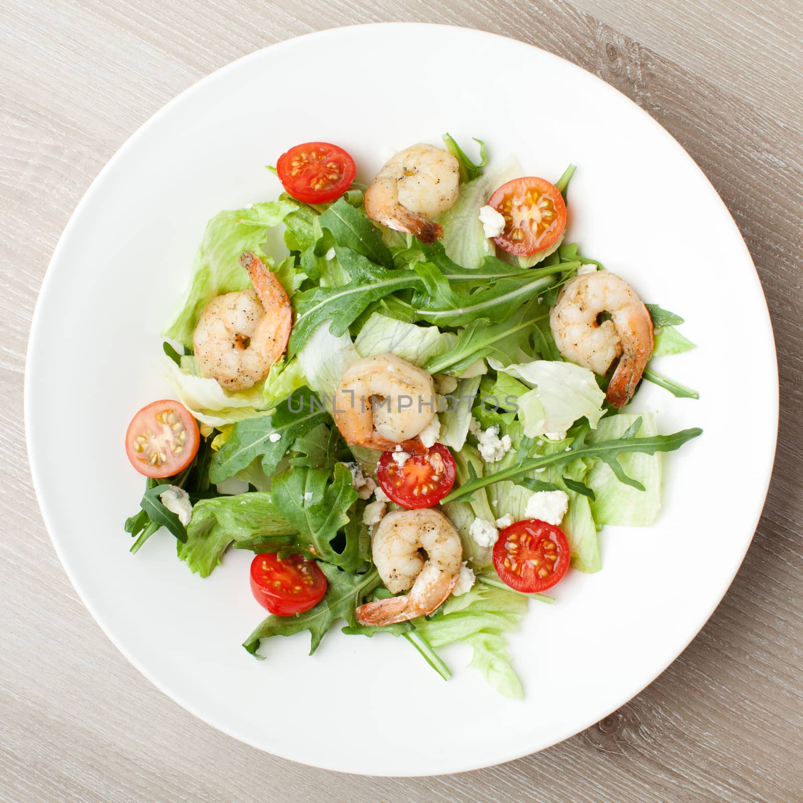 Fresh gourmet seafood salad with shrimps, greens, cherry tomatoe by SergeyAK