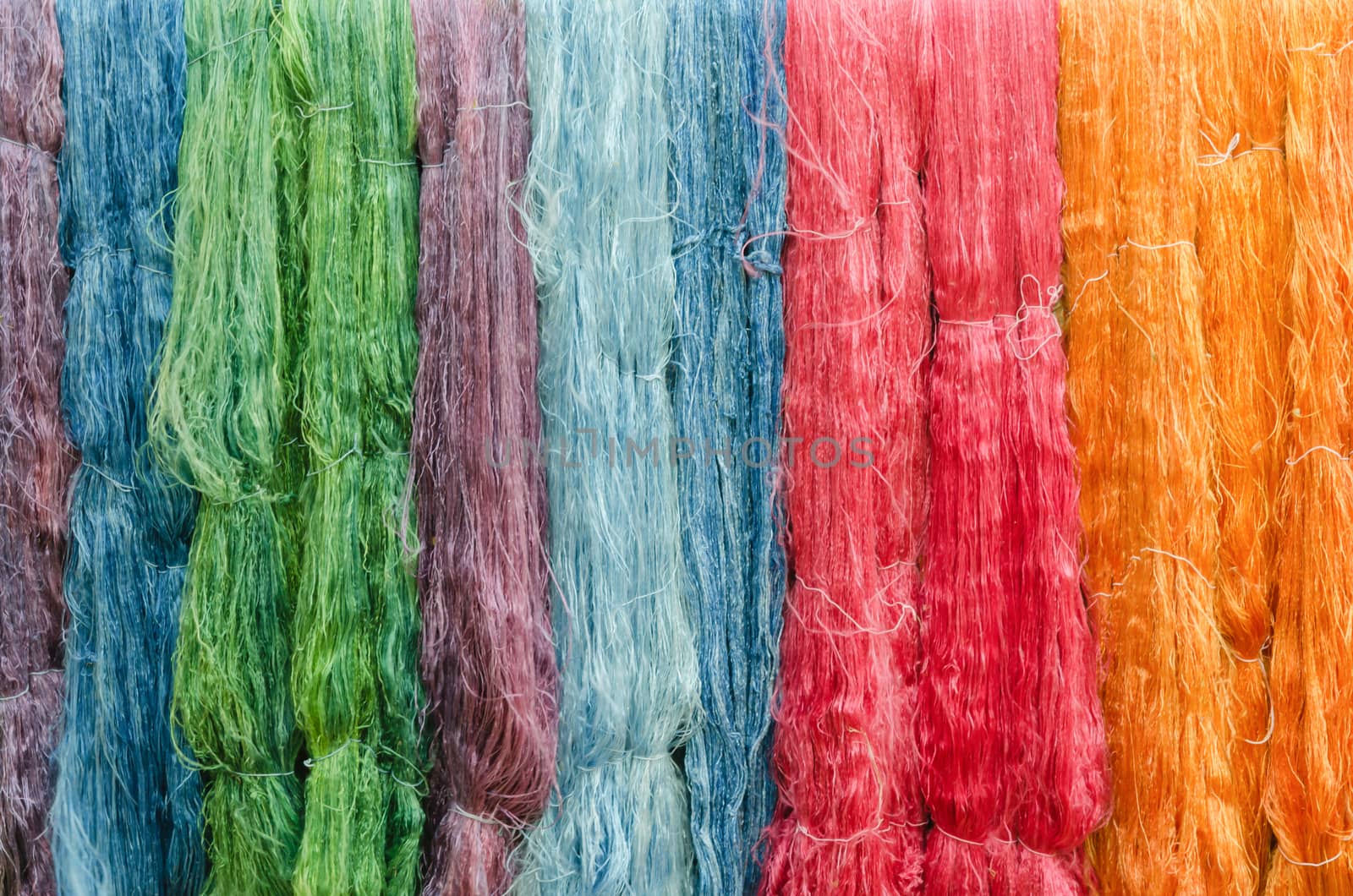 colorful silk yarns being dried  full background