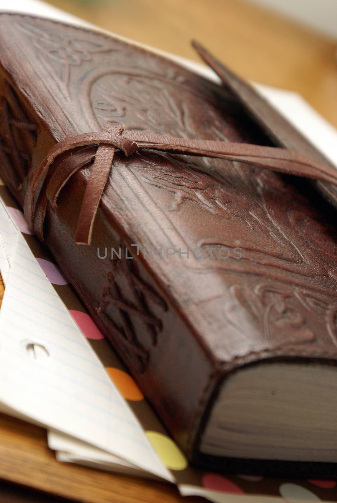 A macro shot of a luxurious leather notbook.