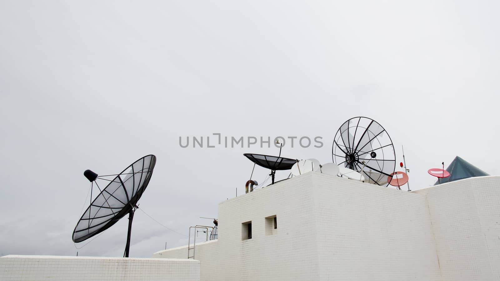 Many satellite dishes on the roof