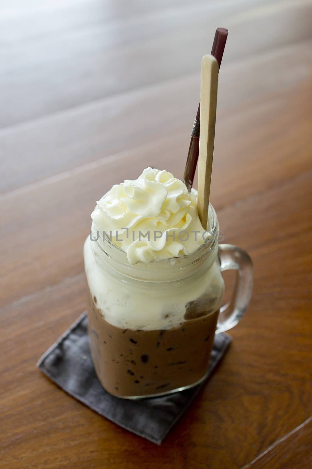 Ice chocolate with whipped cream on table