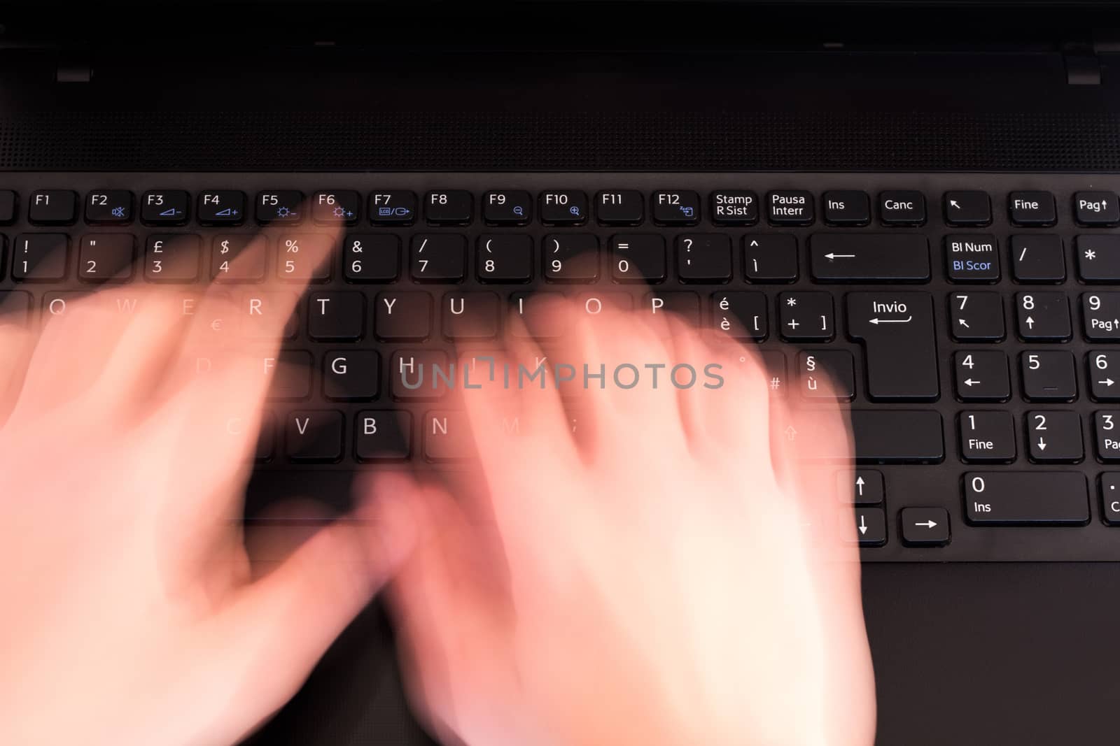 a person writes fast on the keyboard at the office