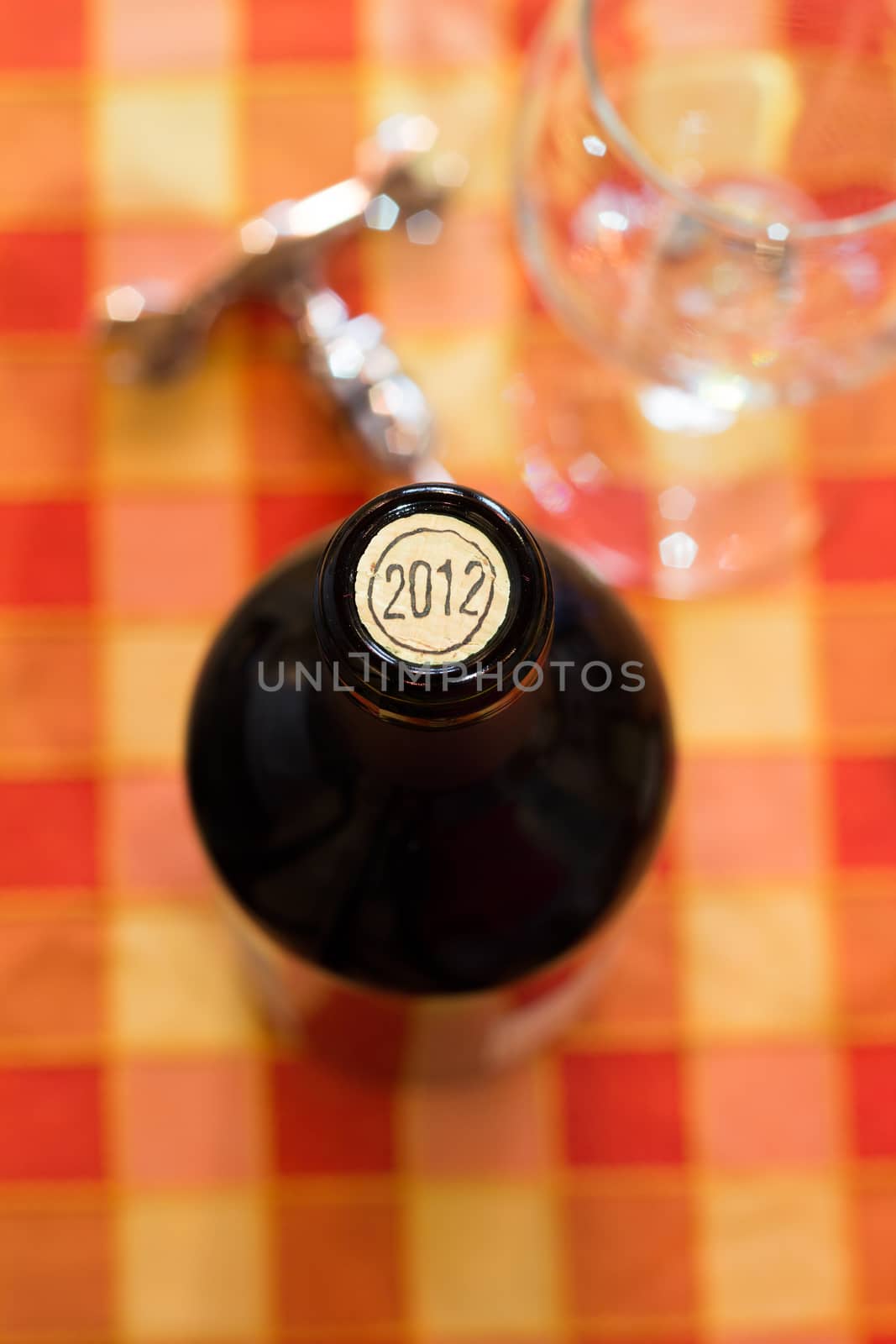 Foreground of opening a bottle of red wine of 2012