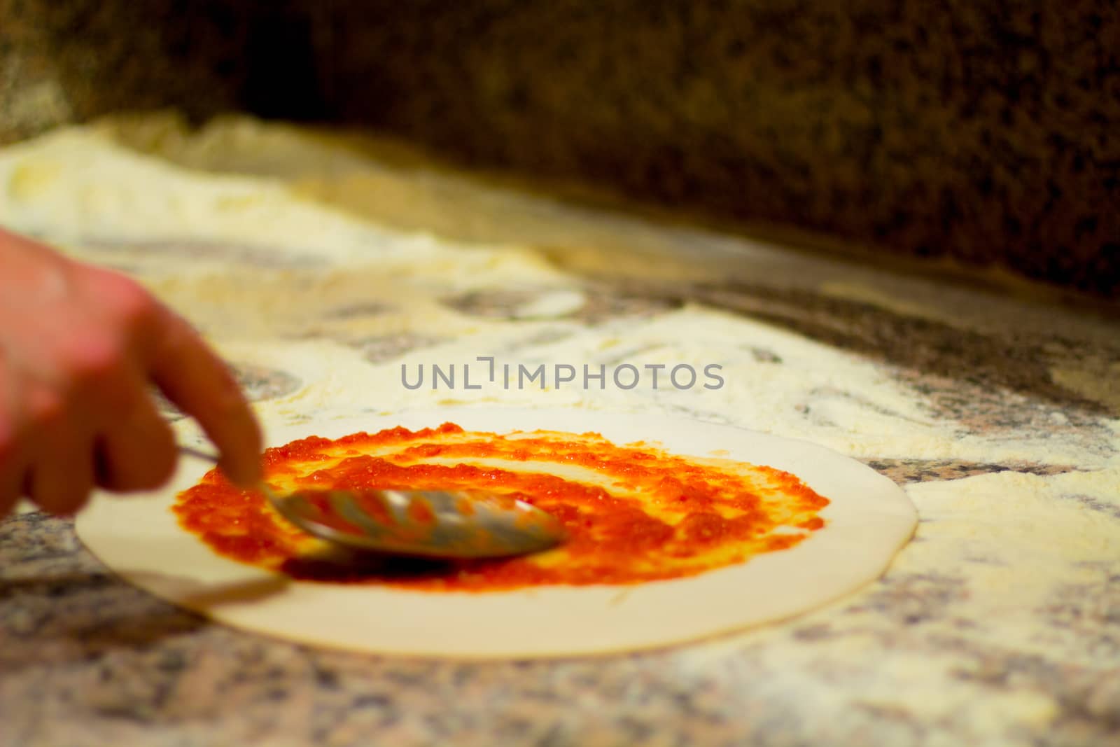 Make a typical italian food, dough, cheese, tomato,