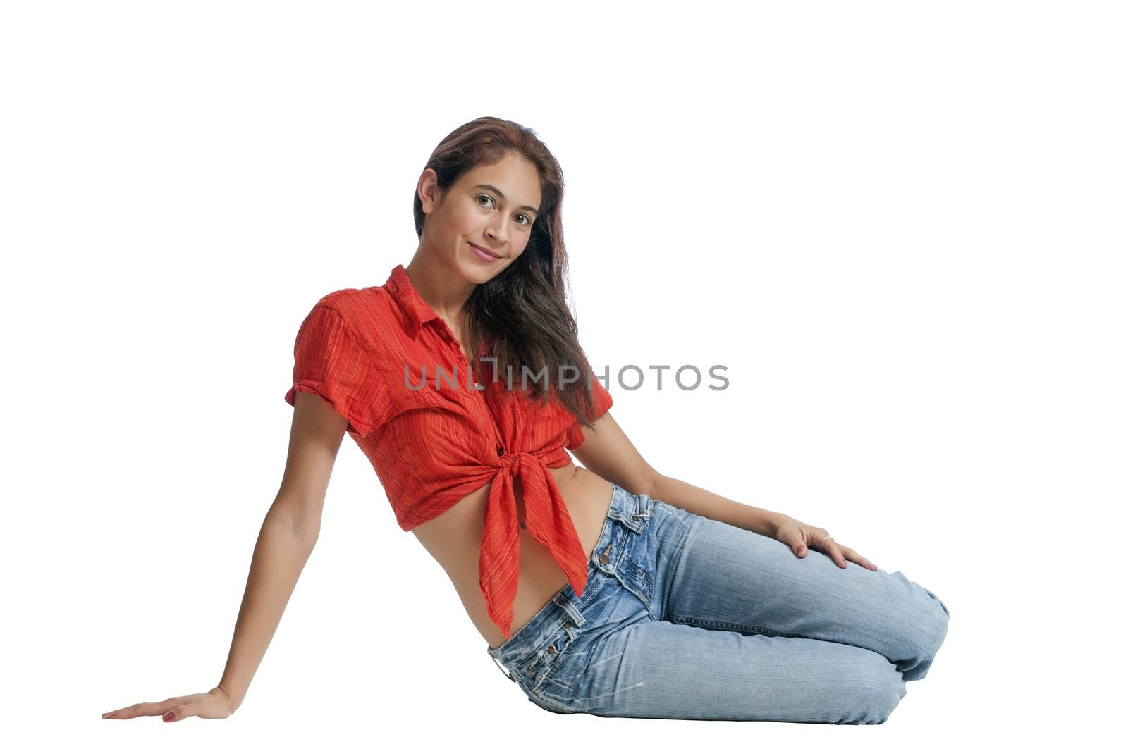 Pretty young brunette sitting on the floor isolated on a white background.