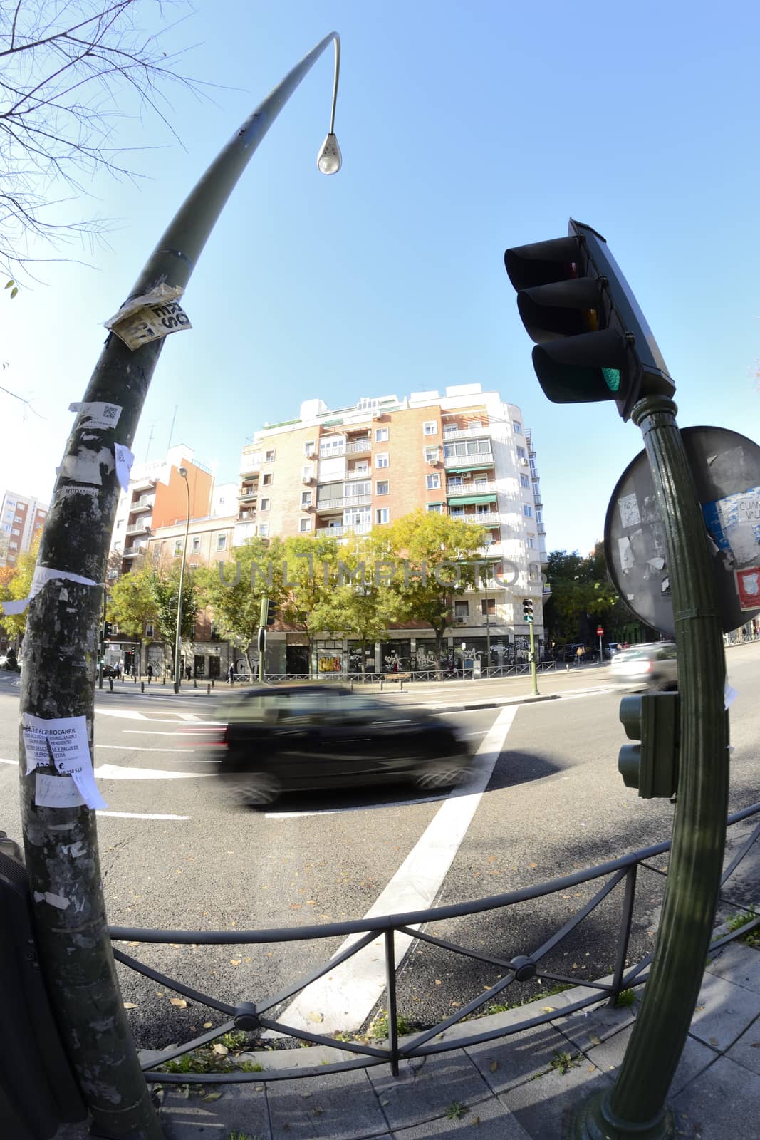 street in movement through a fisheye lens. Car and traffic light