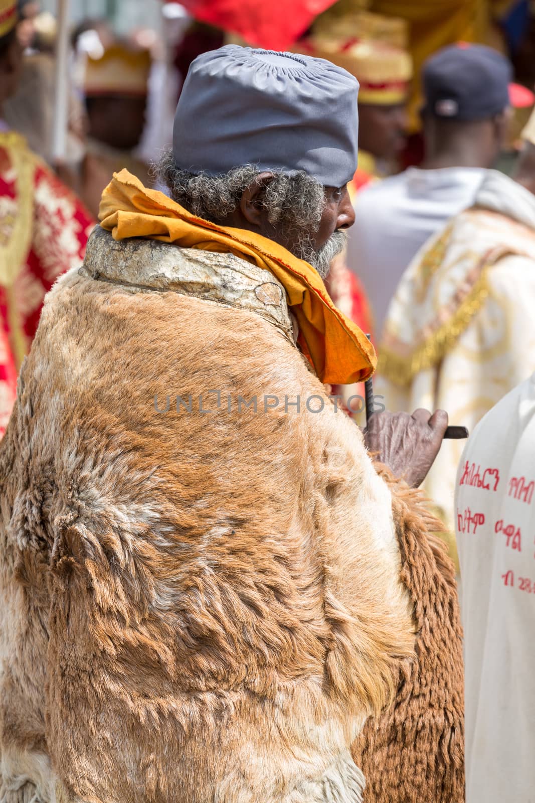 A monk wearing sheep hide patiently waits for the arrival of the tabot, representation of the arc of the covenant, during a colorful procession of the Timket (Epiphany) celebrations, on January 19, 2015 in Addis Ababa.