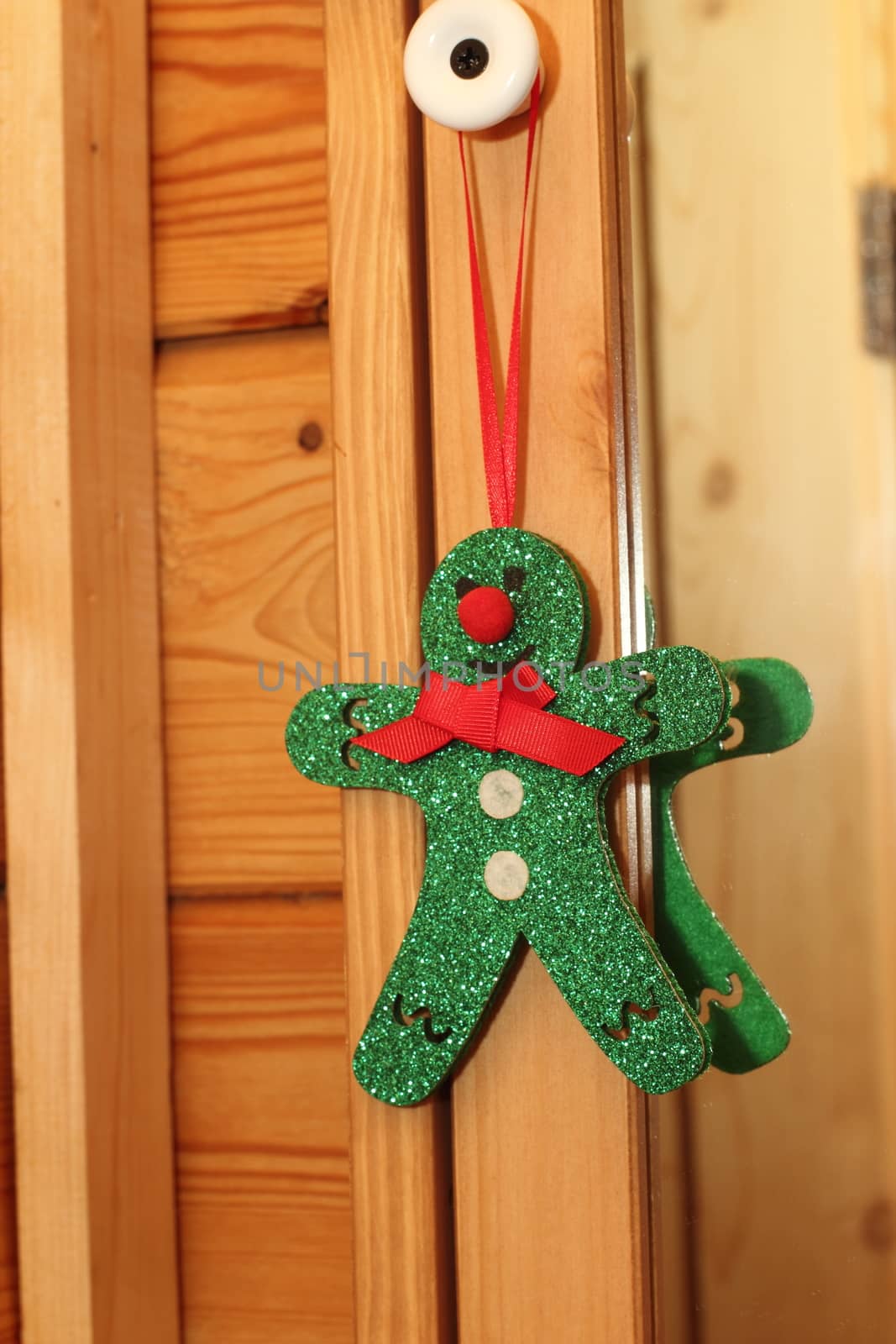 Green Christmas toy man in a wooden house