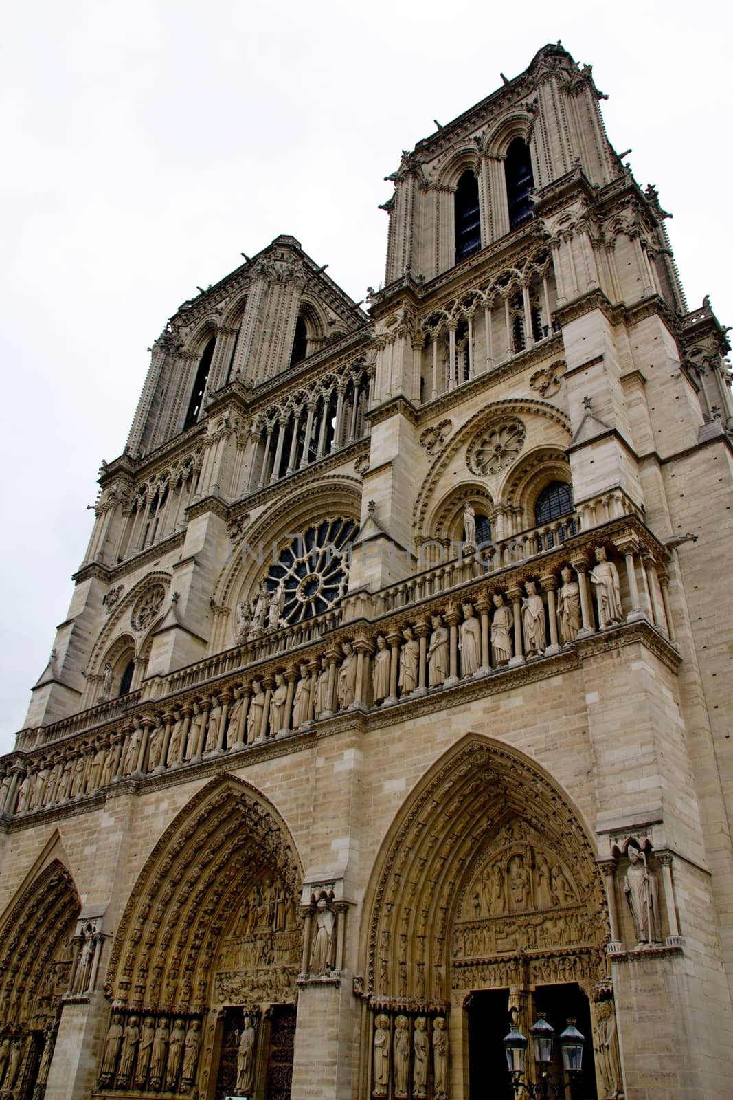 Photo shows Notre Dame de Paris or just Notre Dame that is a historic religious cathedral, on the eastern half of the Île de la Cité in the fourth arrondissement of Paris, France.