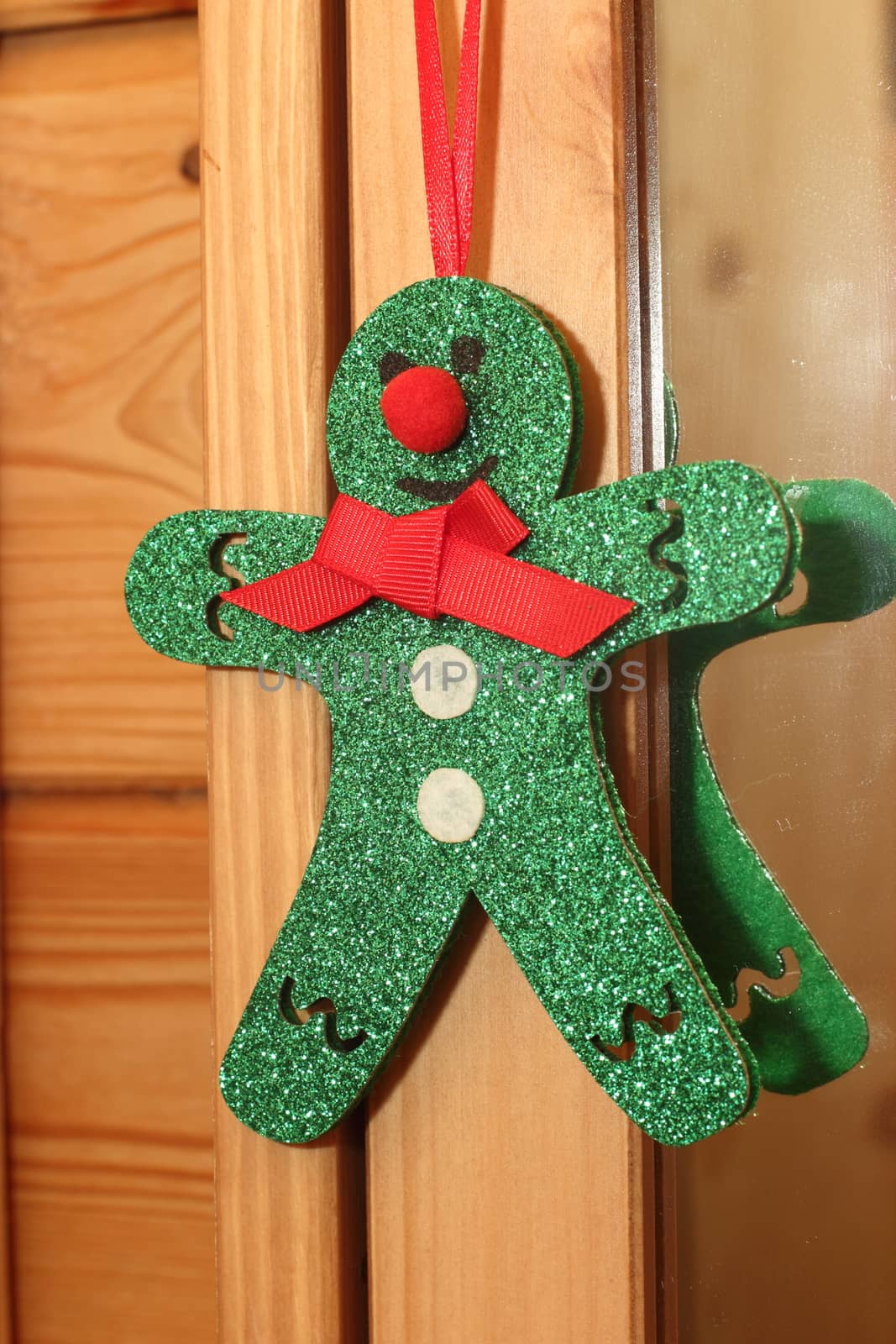 Green Christmas toy man in a wooden house