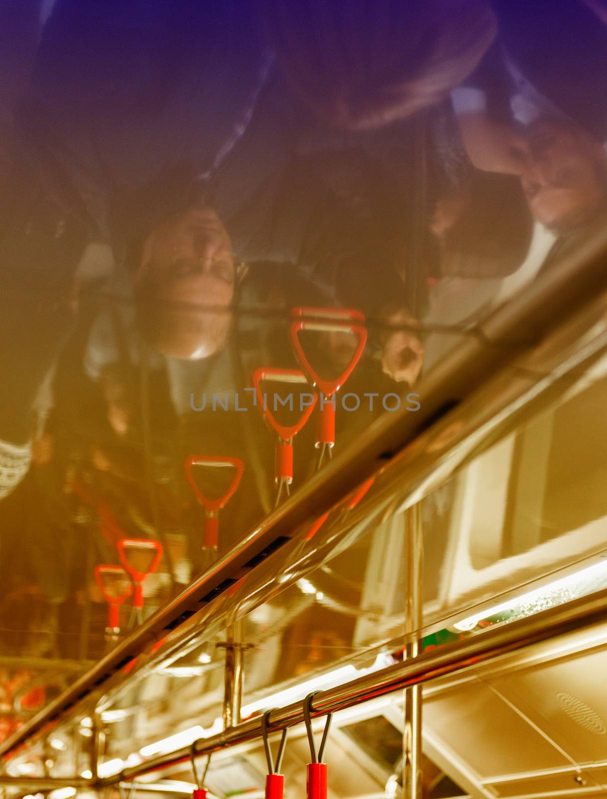 ISTANBUL - OCTOBER 27, 2014: People ceiling reflections in subway train. The subway system currently consists of four lines named M1, M2, M3 and M4.