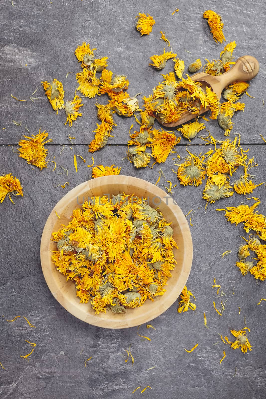 Still life of dried calendula flowers in bowl. Copy space for your text