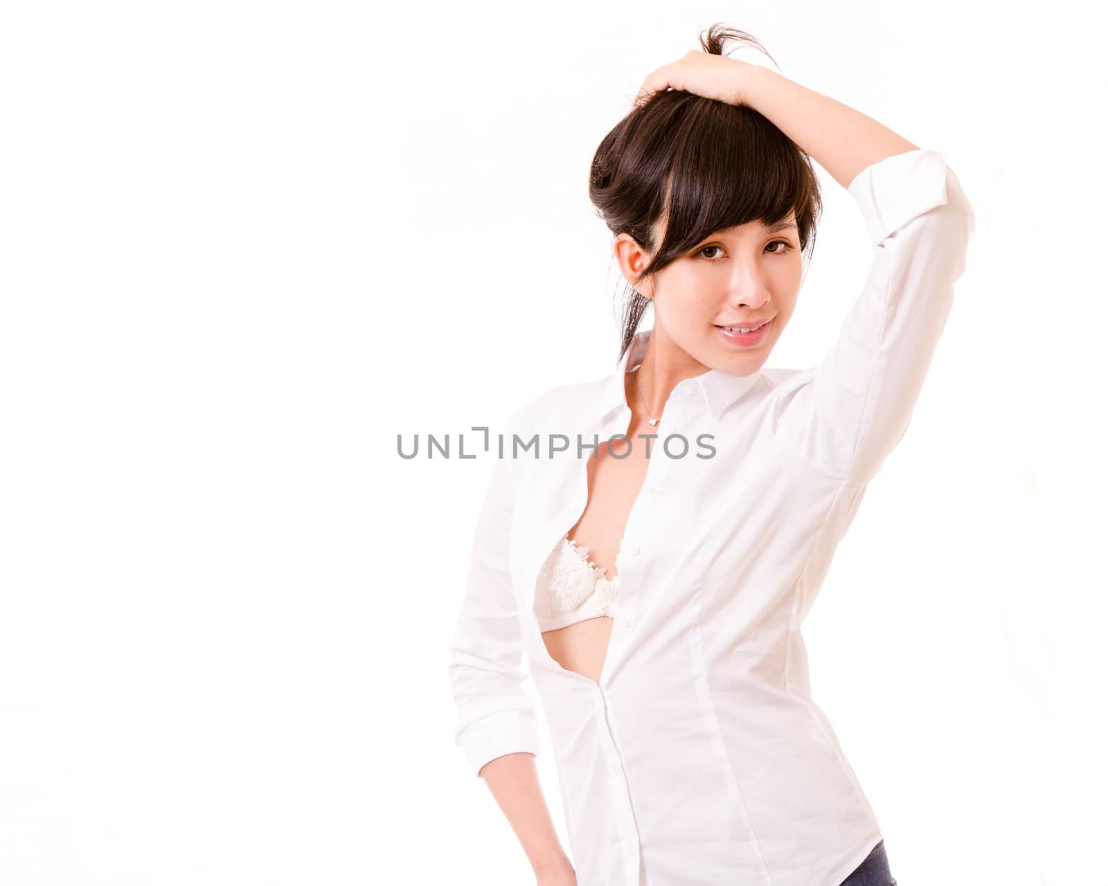 Chinese woman with unbuttoned shirt holding hair