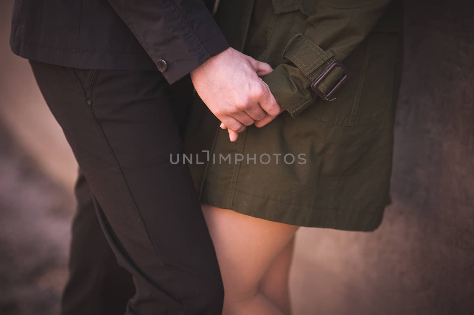 couple holding hands together no face  by fesenko