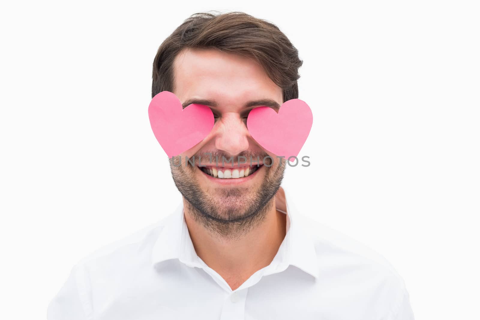 Handsome man with hearts over his eyes on white background