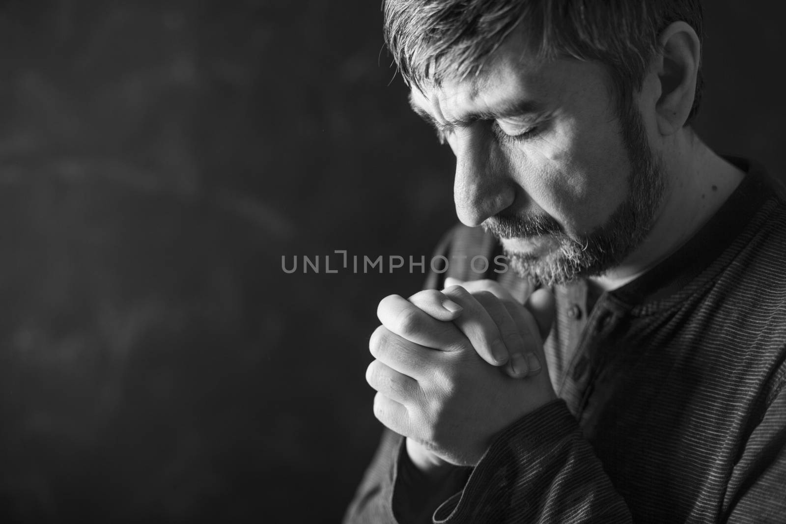 man praying by anelina