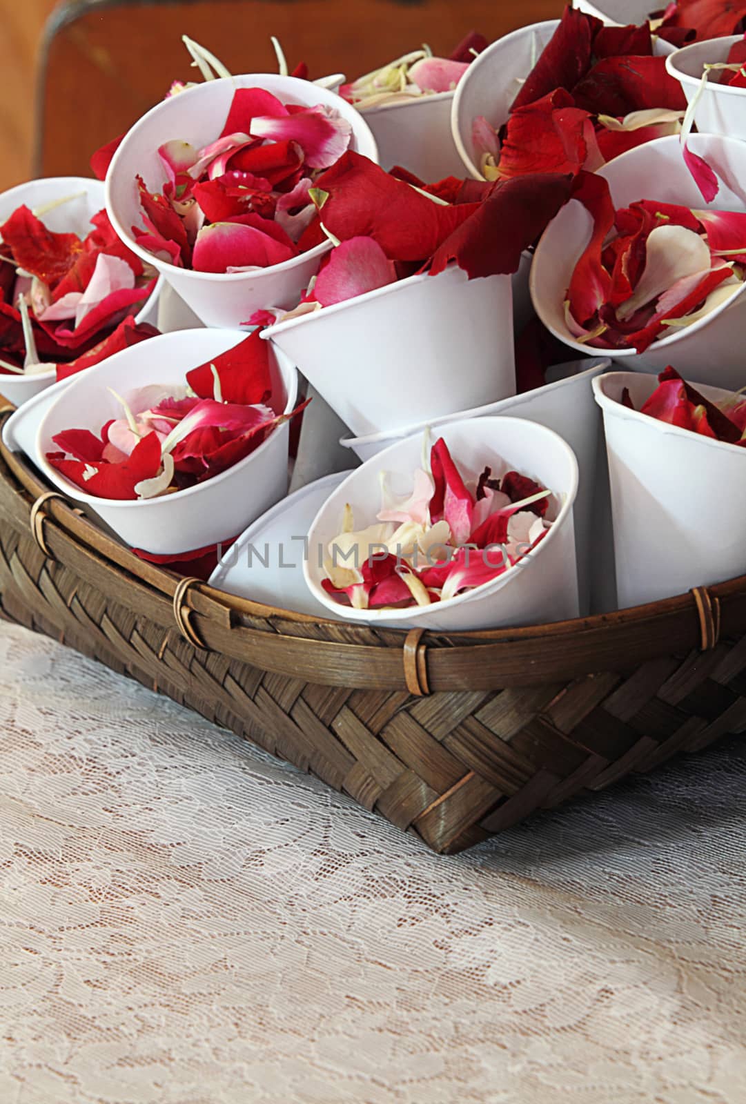 Rose petals in cup for scattering in wedding