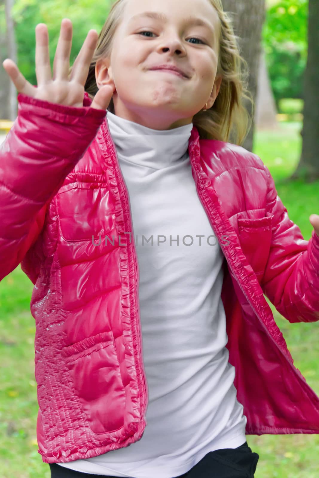 Cute jumping girl with blond hair in summer