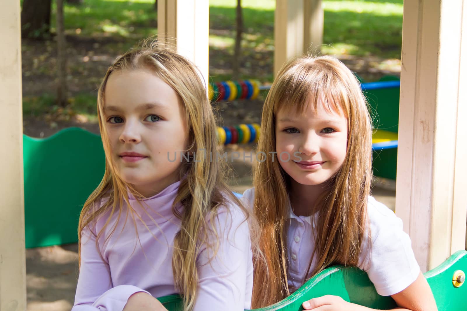 Photo of two playing girls in summer