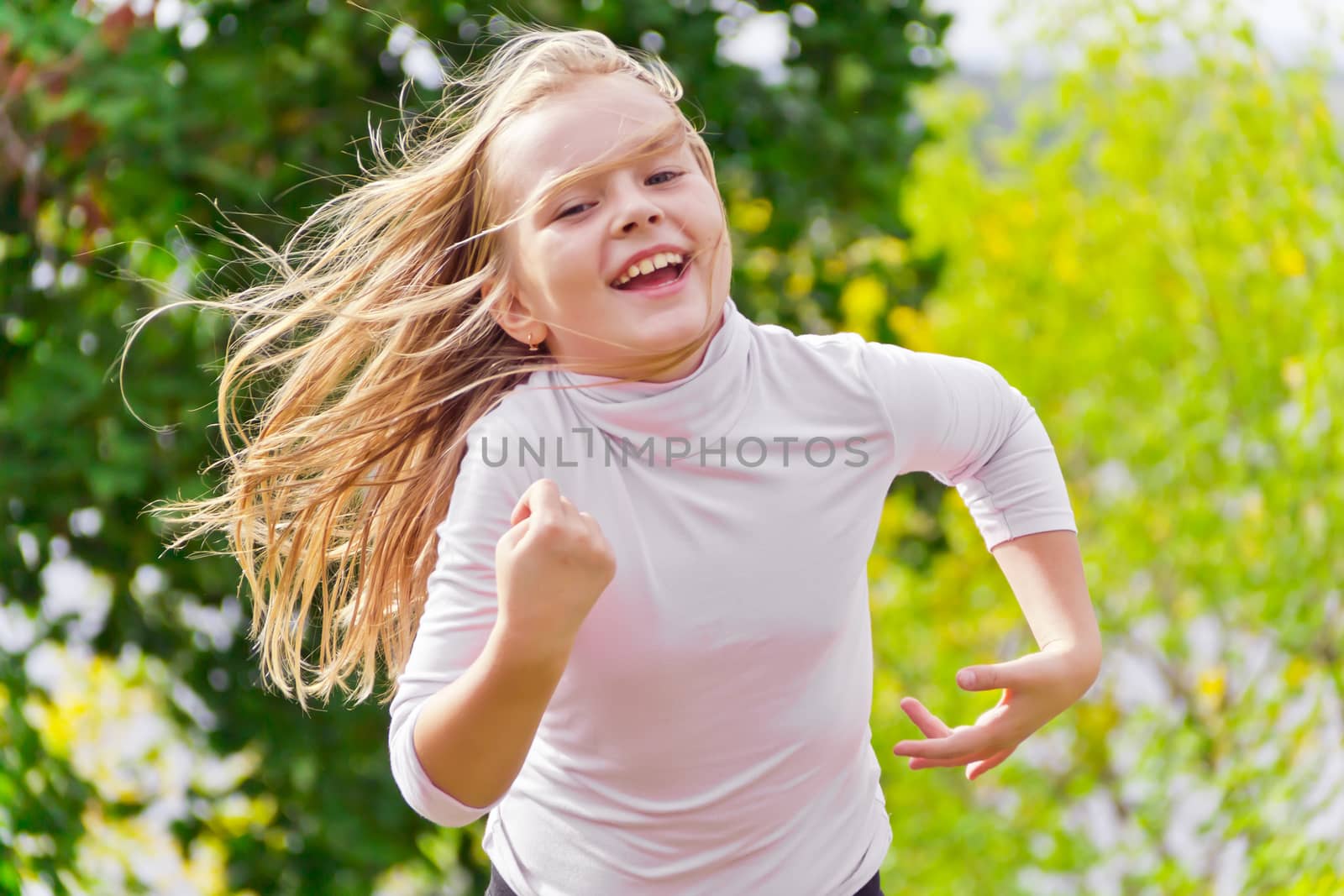 Photo of cute running girl in summer