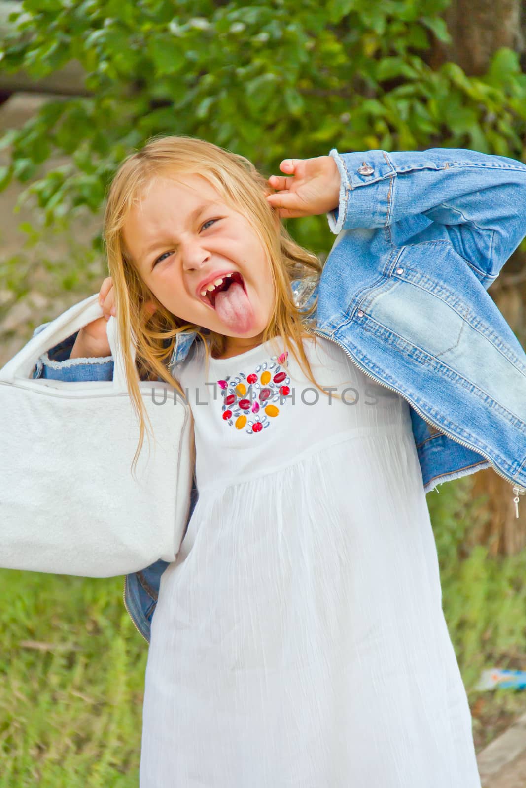 Cute beautiful girl makes faces imitate witch