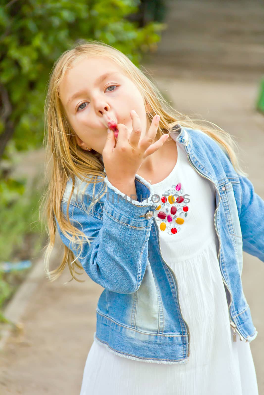 Cute girl with blond long hair in summer